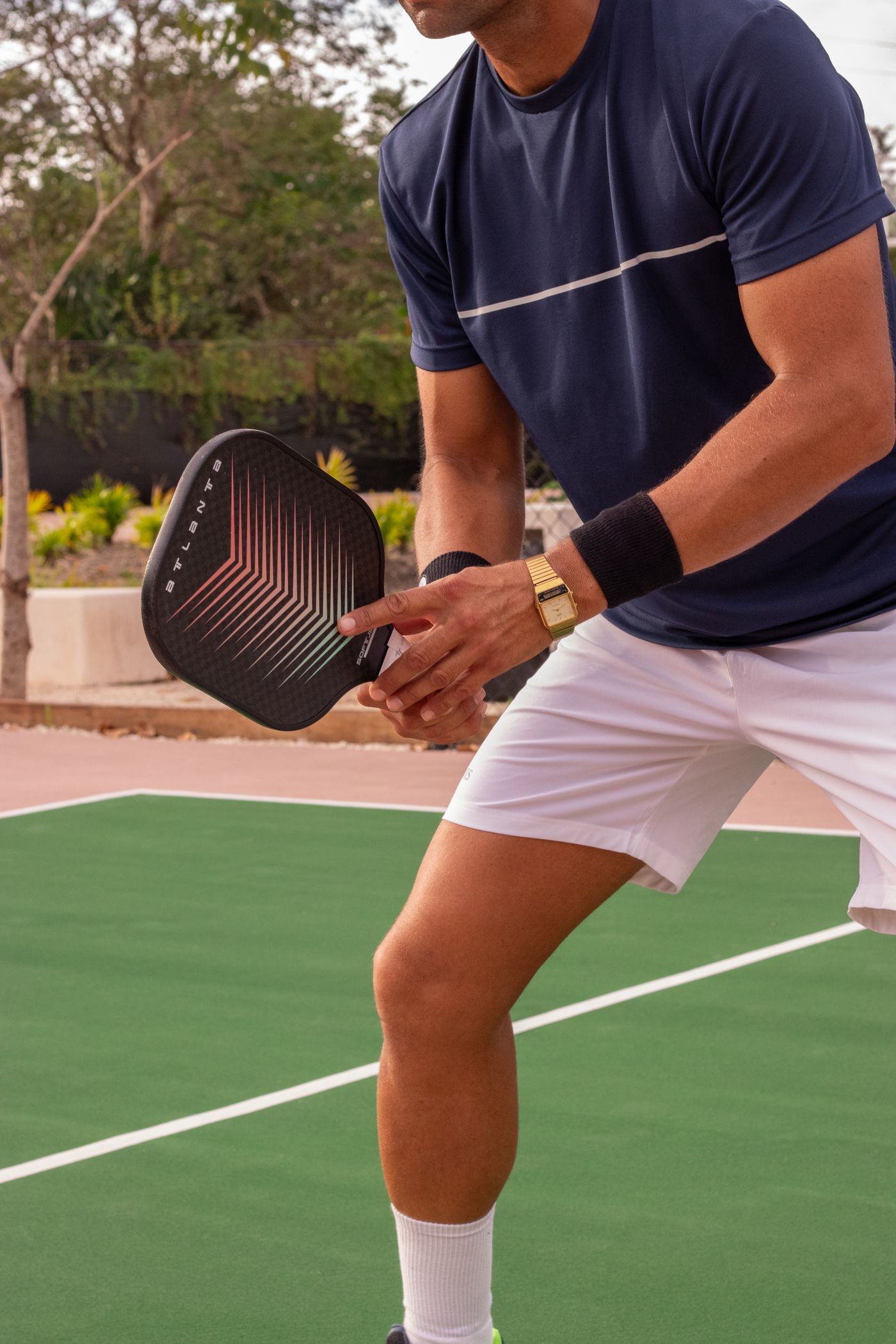Player mid-swing with a pickleball paddle on an outdoor court